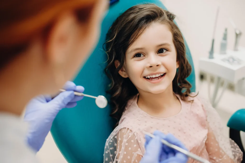 Smiling young girl in a dental chair during a checkup