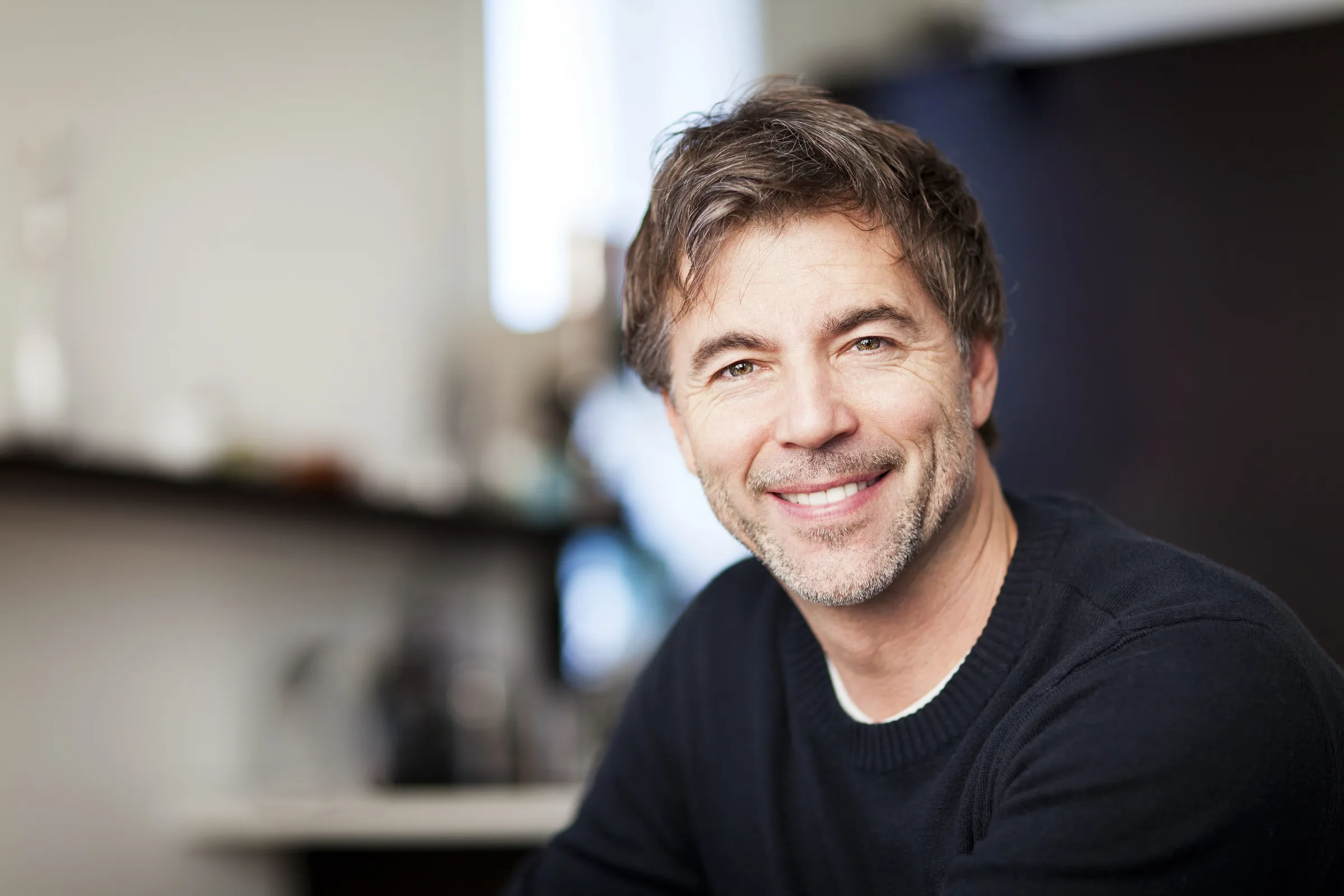 Smiling man in a black shirt