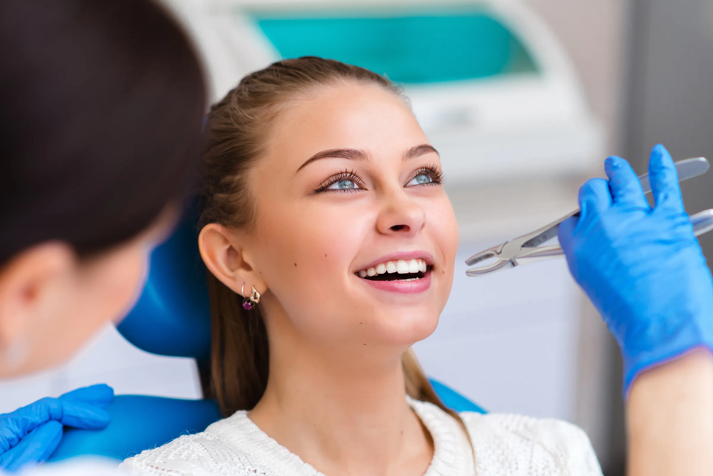 Smiling young woman in a dental chair
