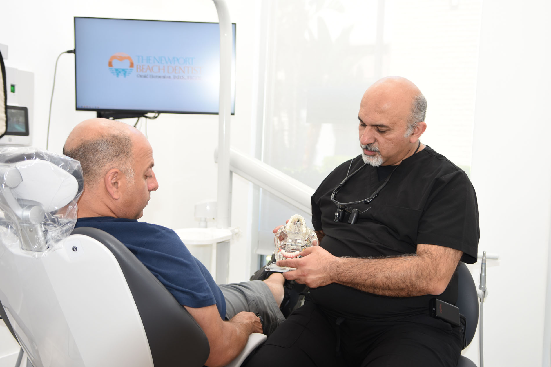 Dr. Haroonian with a patient in the treatment room